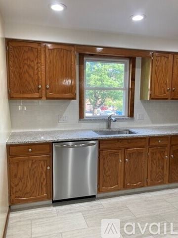 Northford apartment for rent - A kitchen with a granite countertop and wooden floors.