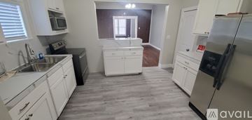 Commerce apartment for rent - A kitchen with white cabinets and a black counter top.