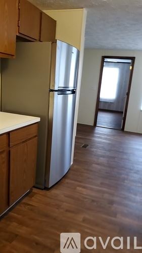Milledgeville house for rent - A kitchen with a refrigerator, cabinets and a counter.