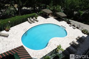 Birmingham apartment for rent - A swimming pool surrounded by a white fence and palm trees.