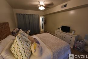 Birmingham apartment for rent - A bedroom with a bed, nightstand, and chair.