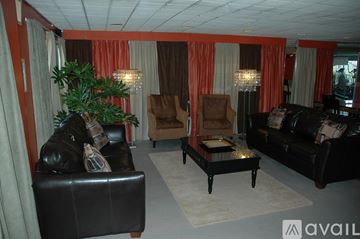 Birmingham apartment for rent - A living room with a black leather couch and a coffee table.