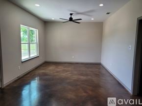 Bullard house for rent - A room with a ceiling fan and brown floor.