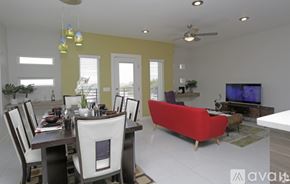 El Paso townhouse for rent - A modern dining room with a red sofa and a television.