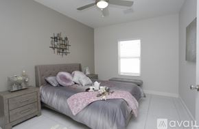 El Paso townhouse for rent - A bedroom with a bed, dresser, and ceiling fan.