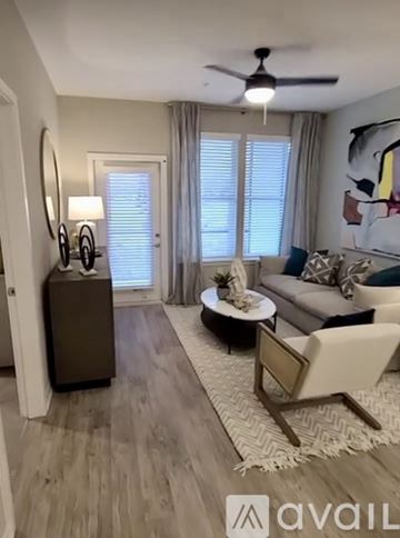 Apollo Beach apartment for rent - A living room with a white couch and a wooden floor.