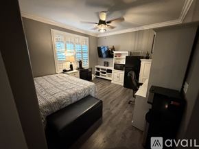 Stockton house for rent - A white door opens to a room with a ceiling fan and a person standing.