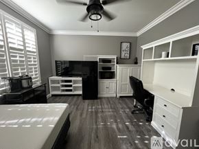 Stockton house for rent - A room with a bed, desk, and chair.