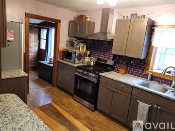Rosendale house for rent - A kitchen with a black stove top oven and a black refrigerator.