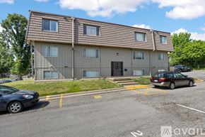 Iowa City apartment for rent - A two-story apartment building with a parking lot in front.
