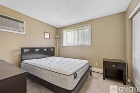 Iowa City apartment for rent - A bedroom with a bed, nightstand, and window.