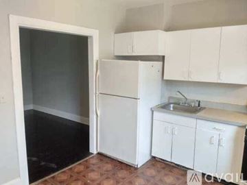 Baltimore house for rent - A kitchen with white cabinets and a sink.