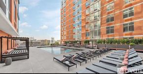 North Bergen condo for rent - A rooftop patio with sun loungers and a pool.