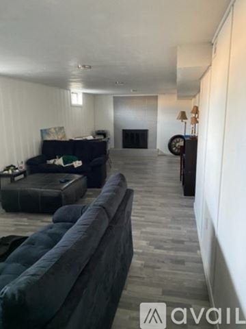 Grand Junction house for rent - A living room with a grey couch and a black sofa.