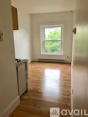 Brookline apartment for rent - A room with a window and a wooden floor.