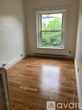 Brookline apartment for rent - A room with wooden floors and a window.