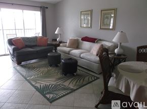 Punta Gorda condo for rent - A living room with a couch, chair, and a rug.