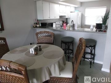 Punta Gorda condo for rent - A kitchen with a table and chairs in the foreground.