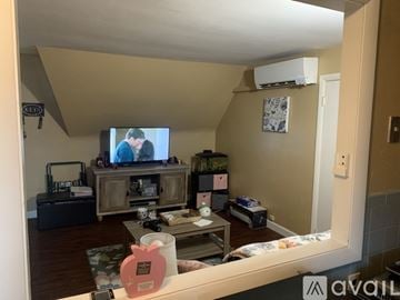 Southbridge apartment for rent - A living room with a television on a wooden stand and a couch.