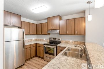 Post Falls apartment for rent - A kitchen with wooden cabinets and stainless steel appliances.