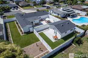 Oceanside house for rent - A large white house with a pool in the backyard.