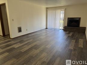 Salem apartment for rent - A spacious room with a fireplace and wooden flooring.