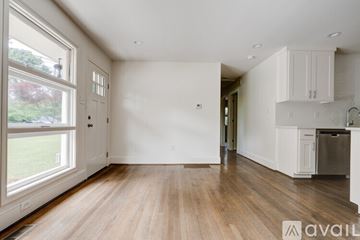 Irondale house for rent - A spacious, empty room with wooden floors and white walls.