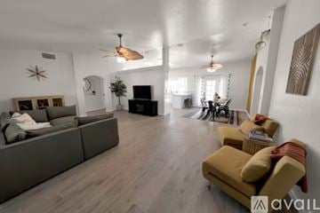 Lake Havasu City house for rent - A living room with a grey couch and a yellow chair.