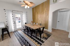 Lake Havasu City house for rent - A dining room with a wooden table and chairs.
