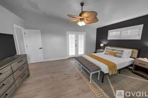 Lake Havasu City house for rent - A bedroom with a bed, dresser, and ceiling fan.