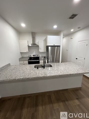 Mission apartment for rent - A kitchen with a granite countertop and stainless steel appliances.