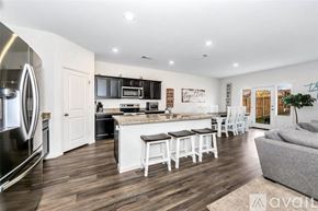 Fort Worth house for rent - A modern kitchen with white cabinets and a wooden floor.
