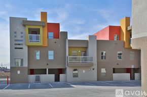 El Paso townhouse for rent - A modern building with a balcony and a parking lot in front.