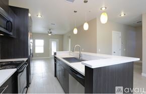 El Paso townhouse for rent - A modern kitchen with a large island and stainless steel appliances.