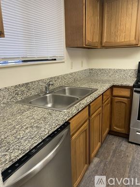Salem apartment for rent - A kitchen with a granite countertop and wooden cabinets.