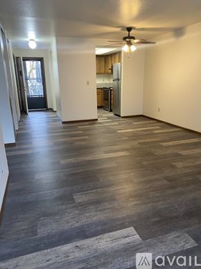 Salem apartment for rent - A spacious room with wooden flooring and a ceiling fan.