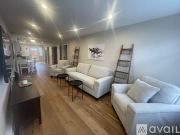 Napa apartment for rent - A living room with white furniture and wooden floors.