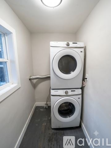 Aurora house for rent - A kitchen with white cabinets and a black stove top oven.