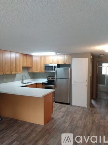 Lynnwood apartment for rent - A kitchen with wooden cabinets and a white countertop.