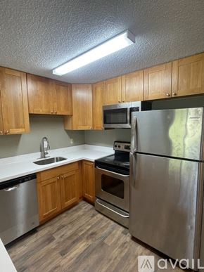 Lynnwood apartment for rent - A kitchen with wooden cabinets and stainless steel appliances.