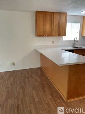 Lynnwood apartment for rent - A kitchen with wooden cabinets and a white countertop.