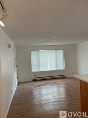Lynnwood apartment for rent - A room with wooden flooring and a window with blinds.