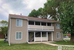 Mankato apartment for rent - A two-story house with a balcony on the second floor.