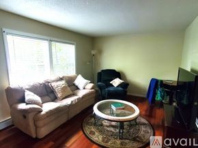 Worcester townhouse for rent - A living room with a couch, chair, and television.