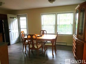Worcester townhouse for rent - A dining room with a wooden table and chairs.