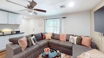 Phoenix house for rent - A living room with a grey couch and a ceiling fan.