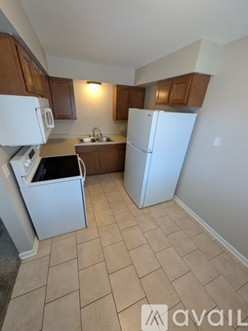 Saint Johns apartment for rent - A kitchen with white appliances and brown cabinets.