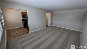 Saint Johns apartment for rent - A room with a striped carpet and a door on the right side.