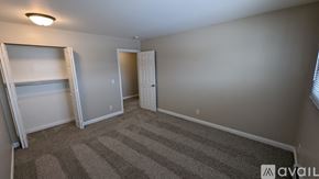 Saint Johns apartment for rent - A room with a striped carpet and a white door.