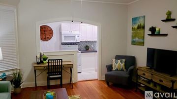 Tampa apartment for rent - A living room with a chair, a table, and a painting on the wall.